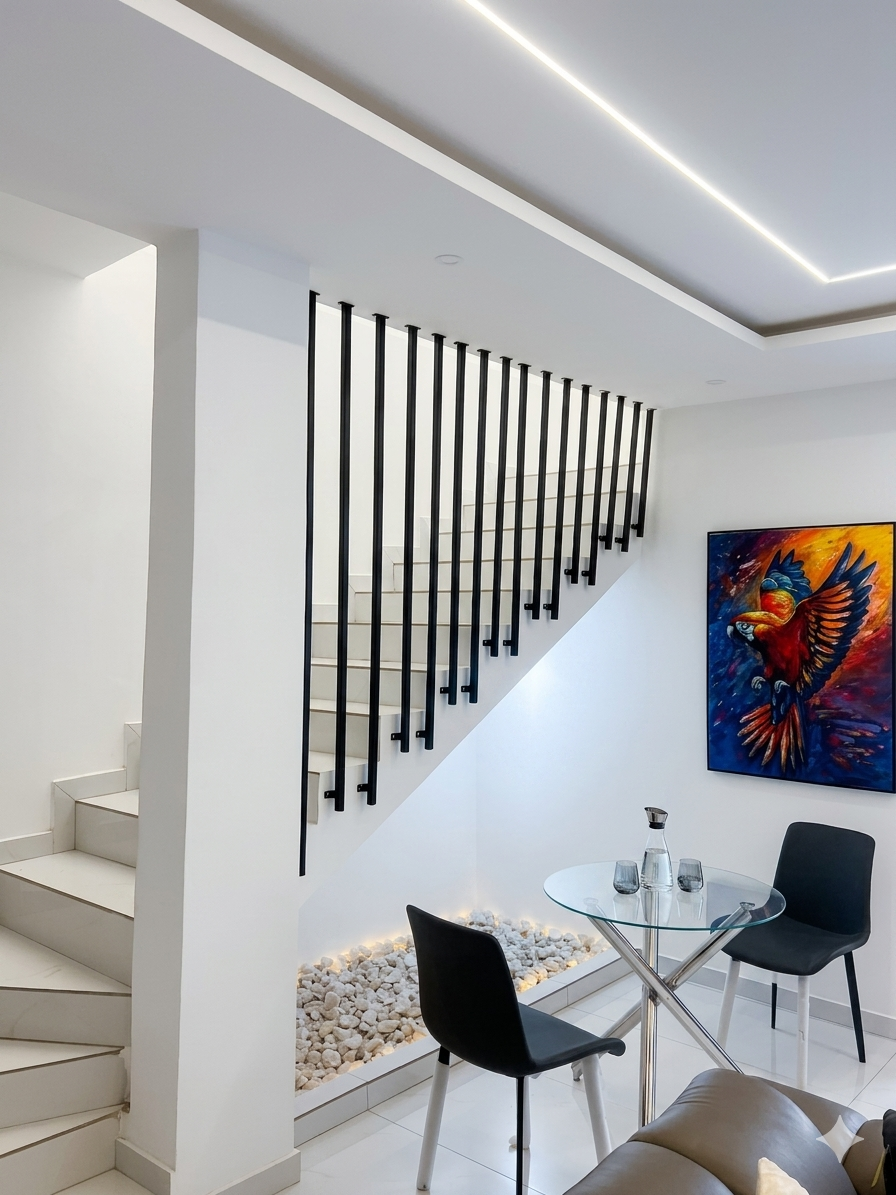 Feature staircase with illuminated pebble garden and original Ghanaian artwork