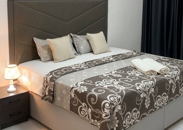 Master suite with king-size bed, warm lighting and en-suite