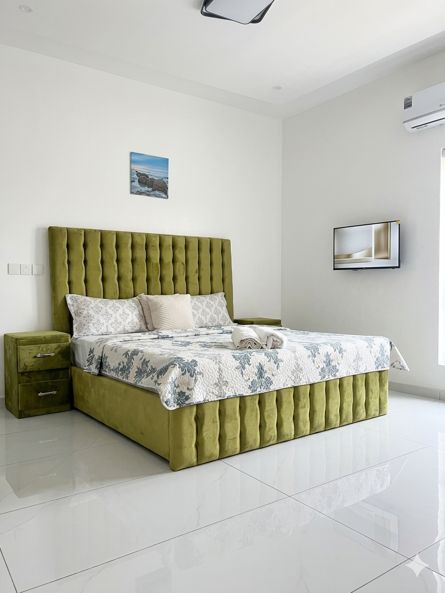 Second bedroom with olive velvet bed and en-suite bathroom